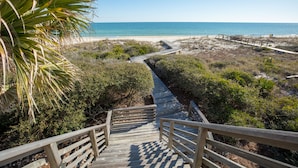 A wooden staircase leading to a beach with a clear view of the ocean. - Beachfront, Plantation, Pet Friendly (Eastpoint)