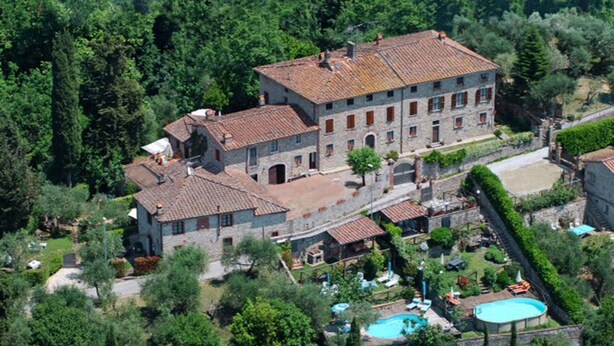 An aerial view of a large stone building with multiple windows and a tiled roof, surrounded by lush greenery and a swimming pool. - Francesca 3 Extra Suite pool and whirlpool (Camaiore)