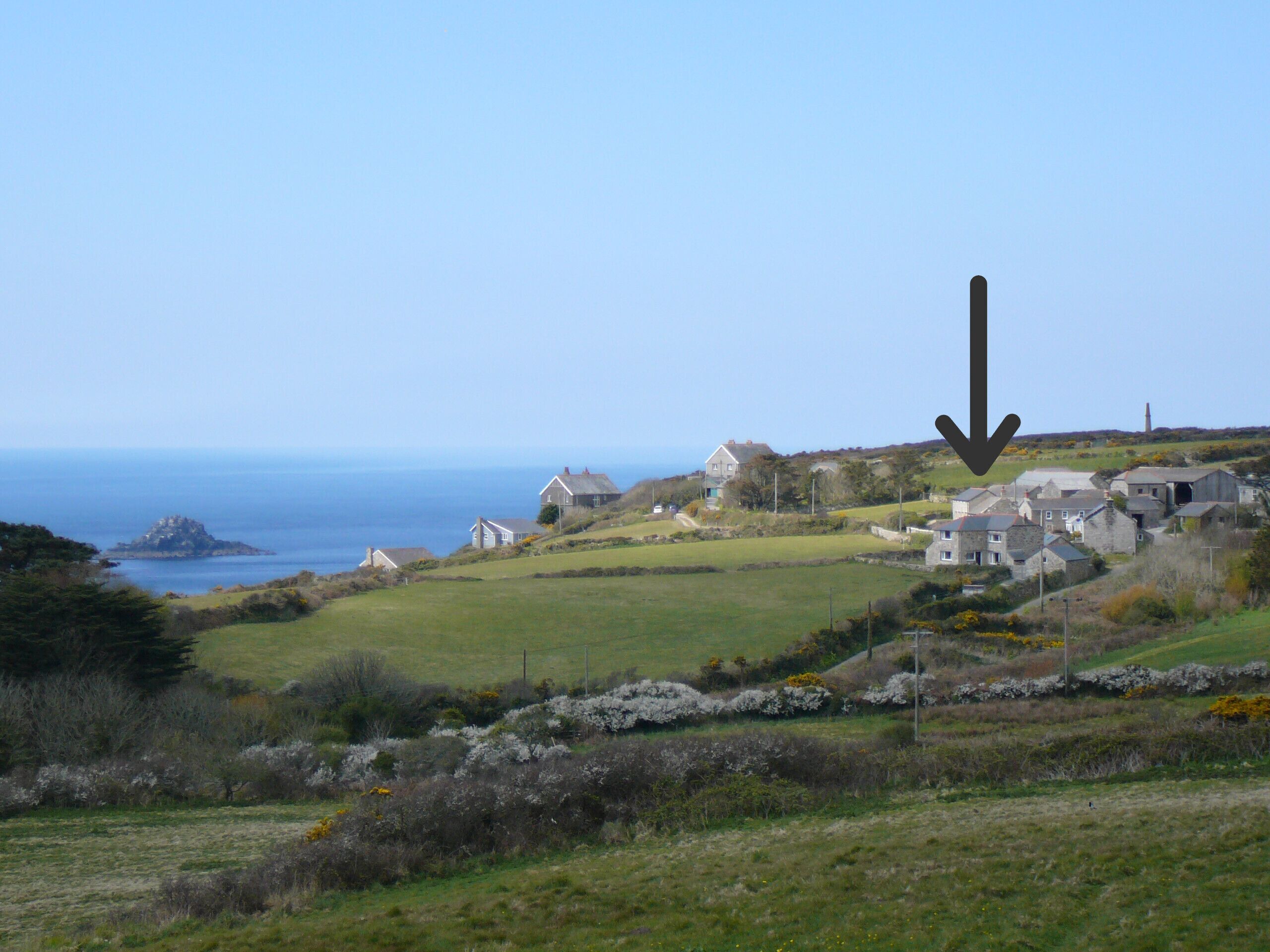 A coastal village with houses and a lighthouse.