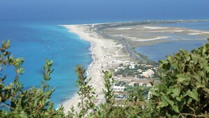 A coastal landscape with a beach, a road, and buildings. - A HOME FROM HOME! Large stone Villa with pool & stunning views - FREE meal out! (Lefkada)