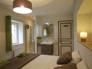 Enjoy a restful stay in this stylish hotel room with a comfortable bed, modern bathroom, and convenient amenities.