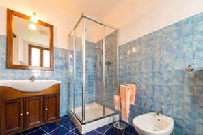 Regadera, secadora de cabello, bidet, toallas