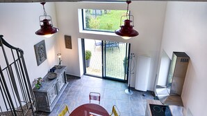 A spacious kitchen with a large island, modern appliances, and a view to the outdoors. - La Grange aux Lumières - Heated swimming pool - Nature (Courcy)