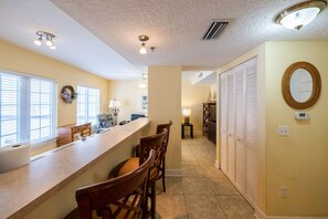 Enjoy cooking in this well-equipped kitchen with a long countertop and comfortable seating for meals.