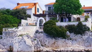 A coastal property with a stone facade, a pool, and a view of the sea. - Villa near Trogir - private beach, bbq, parking, turqouise sea, boat rental :) (Rogoznica)