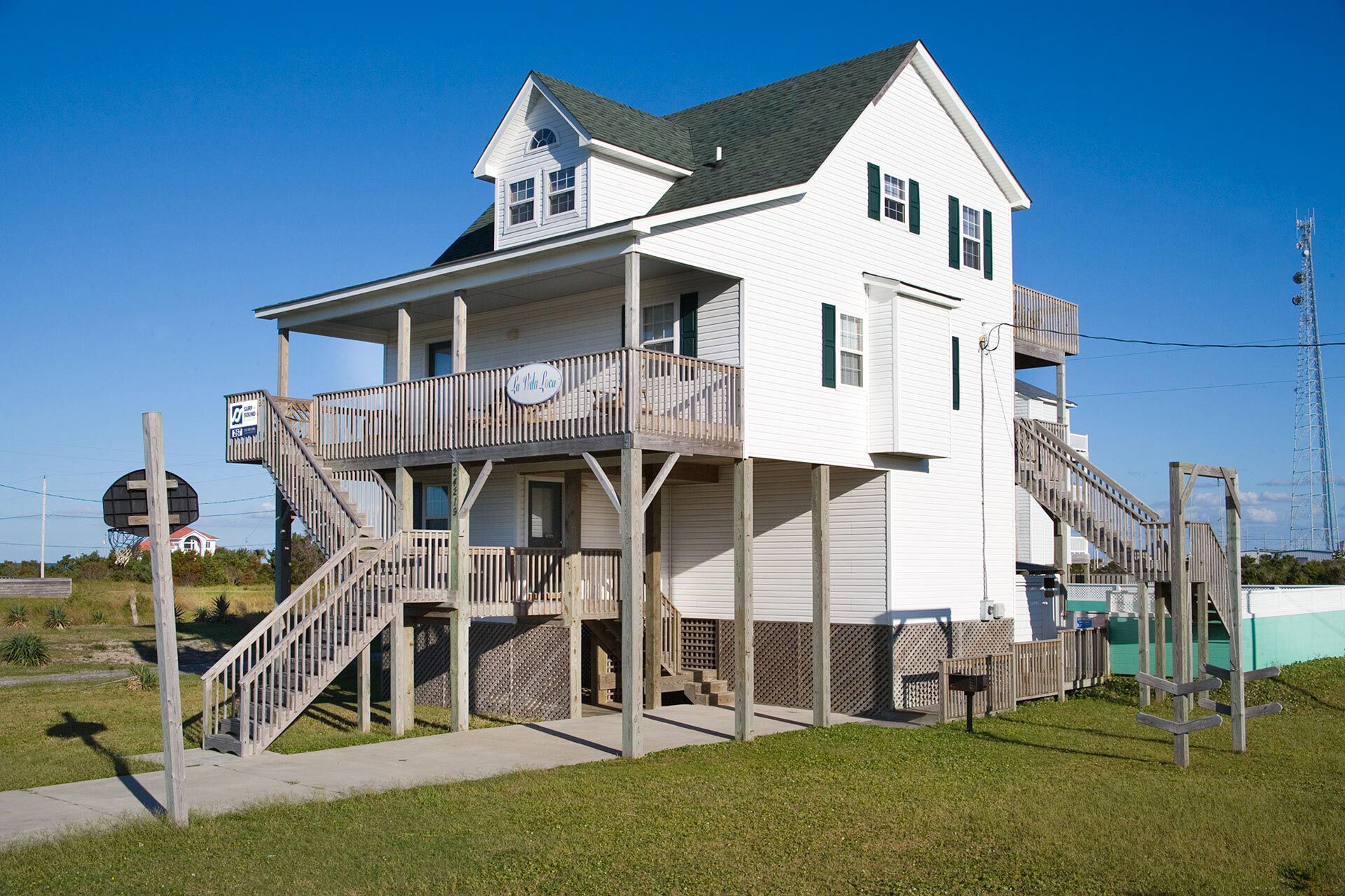 A two-story house with a balcony and a staircase leading to the upper floor.
