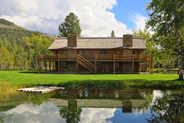 Custom built log cabin with pond situated on 4 pristine acres