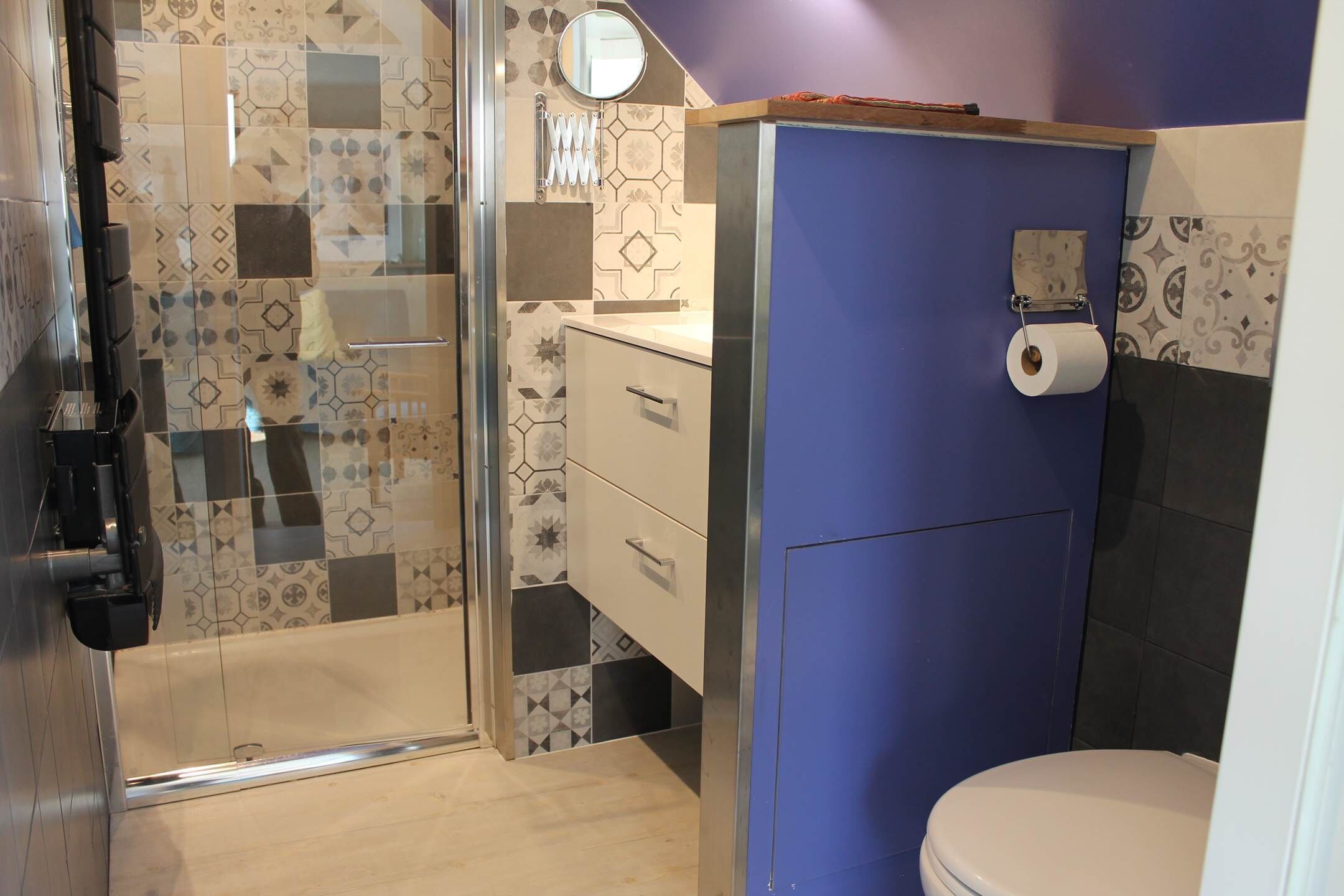 A bathroom with a shower, toilet, and sink.