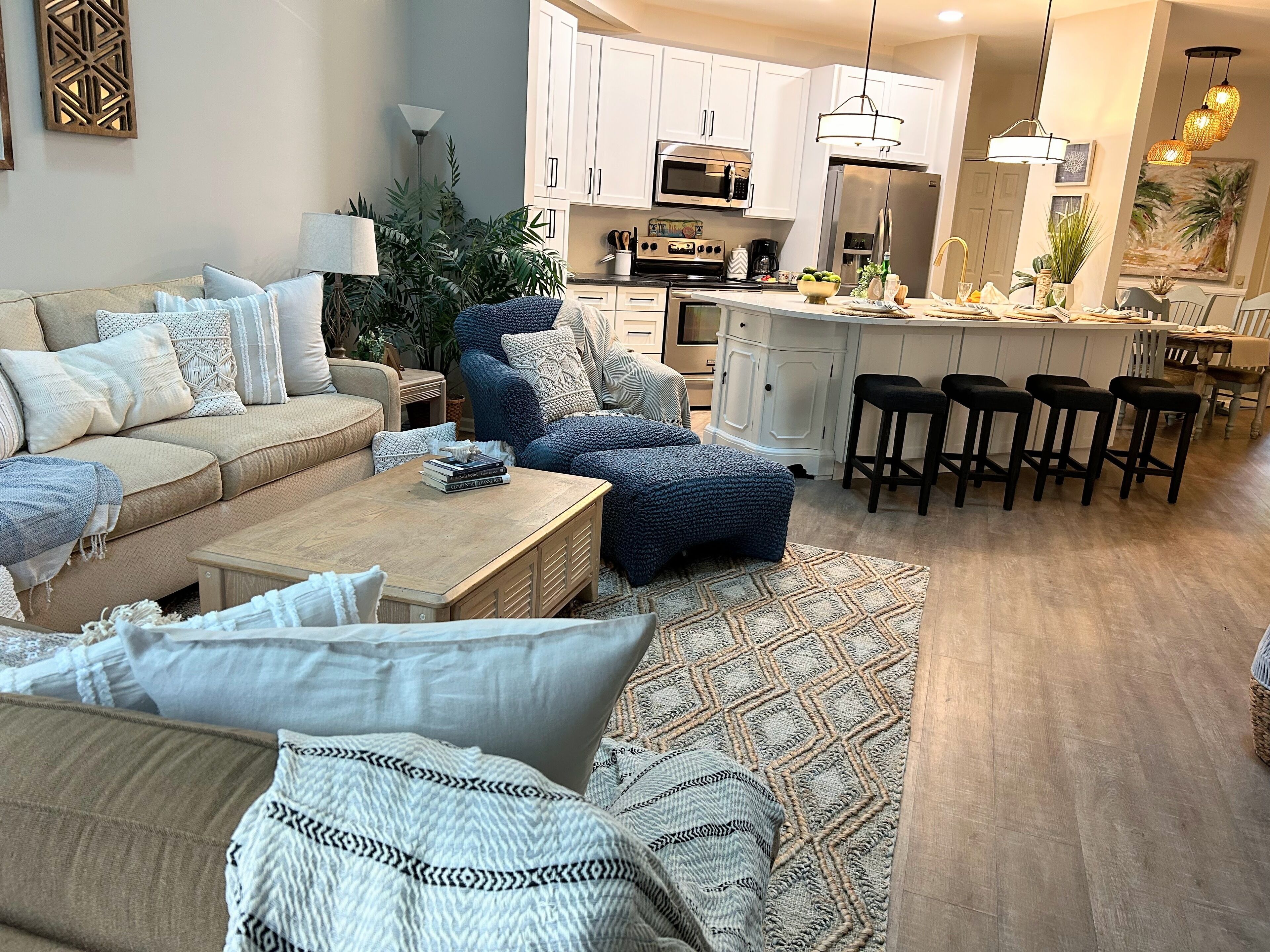 Open Living Area with 75" big screen tv and easy access to the kitchen.