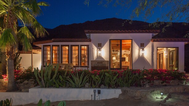 A two-story house with a white exterior, large windows, and a tiled roof. - STUNNING LUXURY ESTATE IN THE EXCLUSIVE MESA AREA OF PALM SPRINGS (Palm Springs)