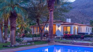 A poolside view of a house with a swimming pool, palm trees, and a mountainous backdrop. - STUNNING LUXURY ESTATE IN THE EXCLUSIVE MESA AREA OF PALM SPRINGS (Palm Springs)