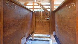 A wooden interior with a wooden staircase leading to a door.