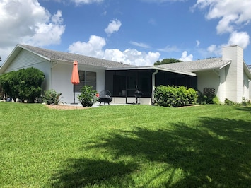 Backyard features a screened in porch & an open area porch w/ fireplace.