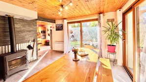 A modern kitchen with a wood ceiling, a built-in oven, and a large window. - CHALET "Les roses de Jean" 2 to 10 people (VENOSC)
