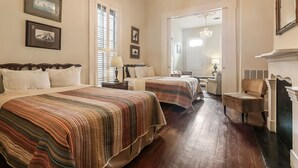 A hotel room with two beds, a fireplace, and a large mirror. - Prime Location just steps from the French Quarter & 3 Blocks to Bourbon St, (New Orleans)