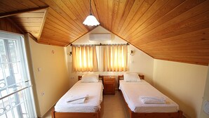 A room with two wooden beds, a window with a view, a ceiling fan, and a light fixture. - Brooklandparis Villa by Nokta Villa (Fethiye)