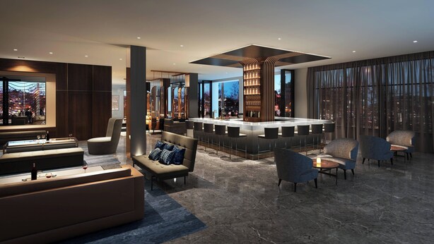 Un moderno vestíbulo de hotel con zona de bar, asientos y vistas a la ciudad.