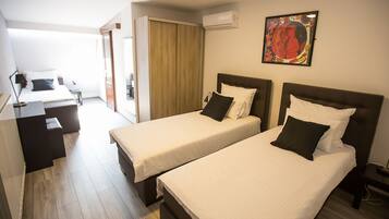 Family Triple Room, 3 Twin Beds | In-room safe, individually furnished, desk, blackout drapes