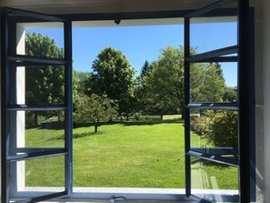 Enjoy the serene view of the well-maintained lawn and trees from the comfort of your room.
