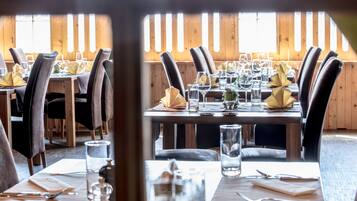 A restaurant with wooden walls and tables set for dining.