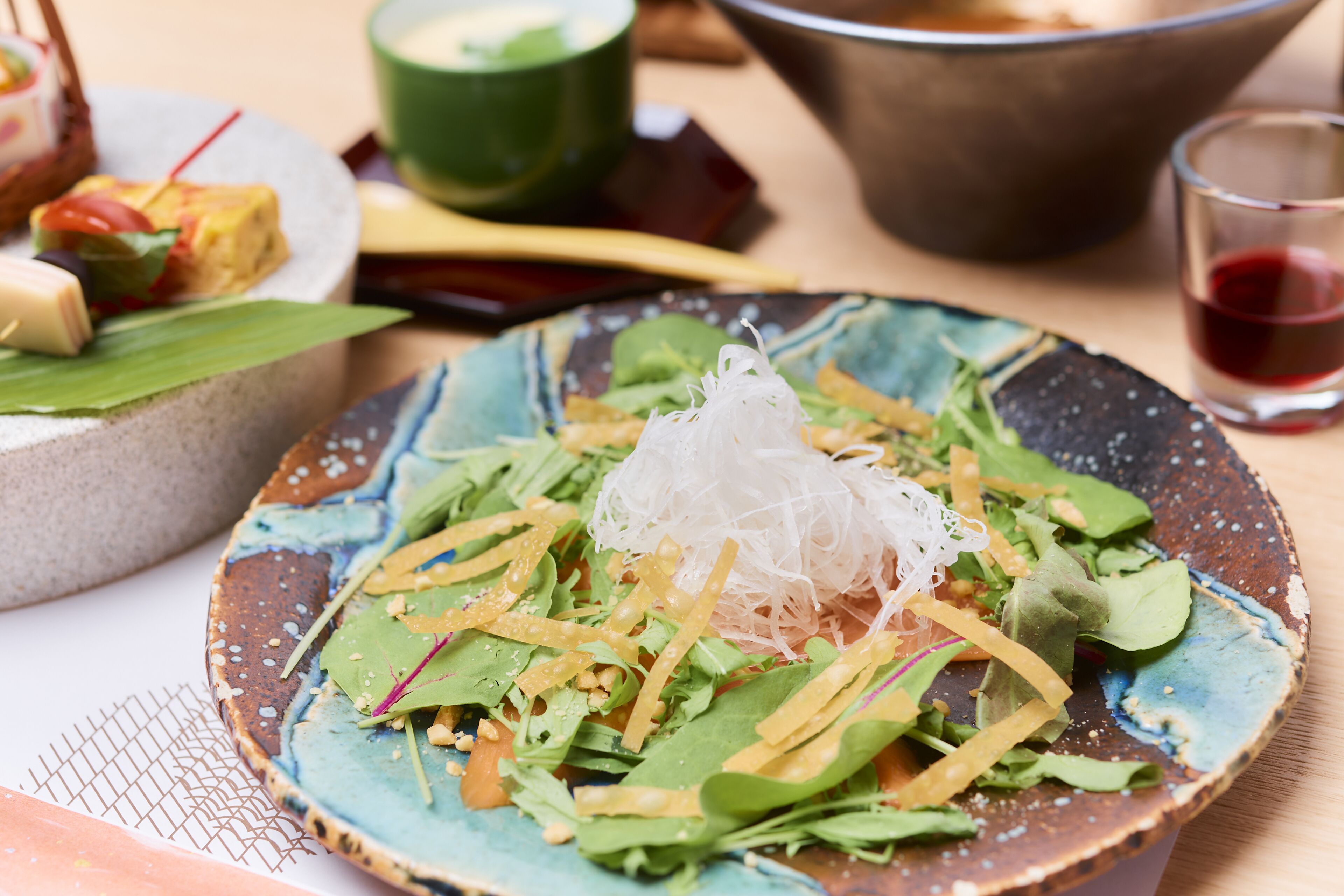 A plate of fresh salad with various greens and shredded vegetables.