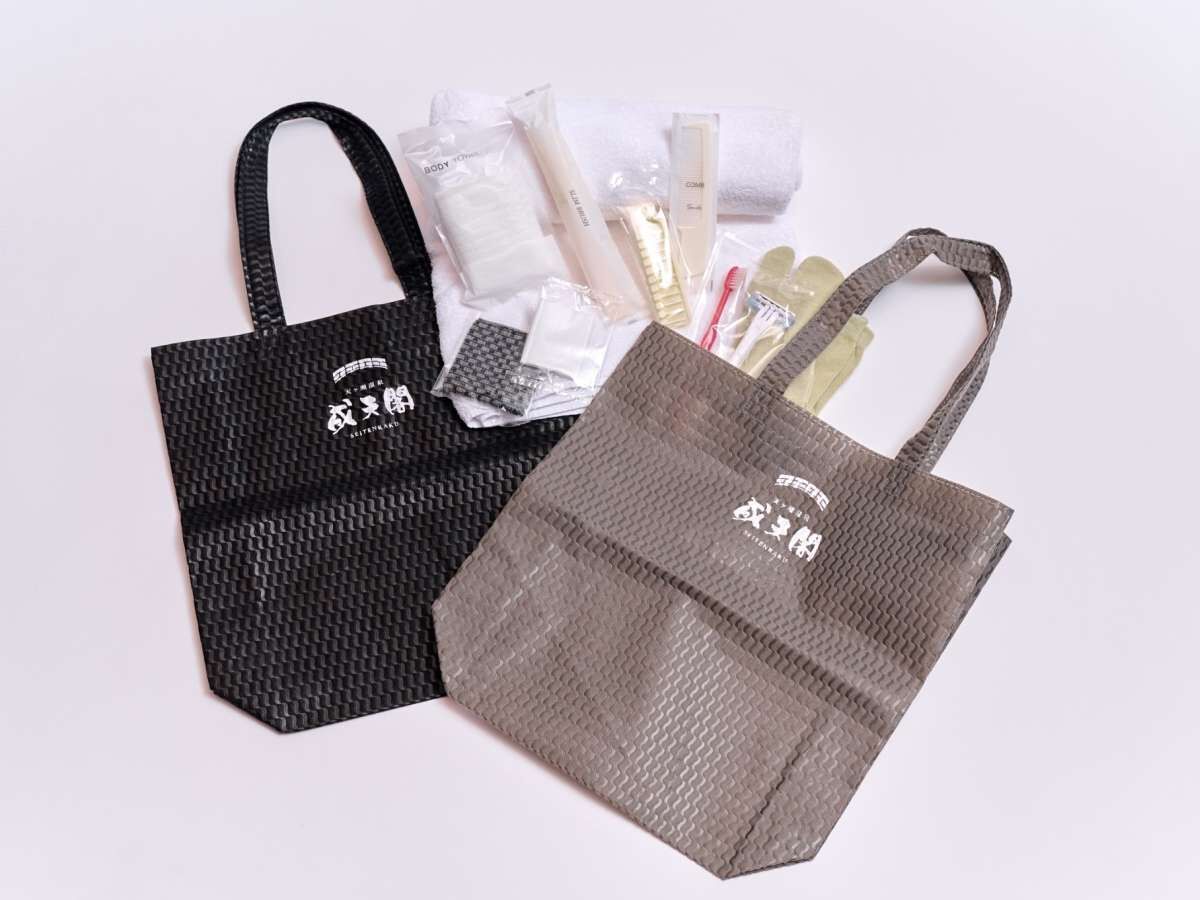 Two bags with a textured surface and a logo, placed on a flat surface.