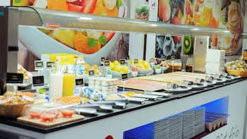 A buffet with various food items and beverages.