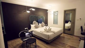 Habitación de hotel moderna con una cama grande, un escritorio y una silla.