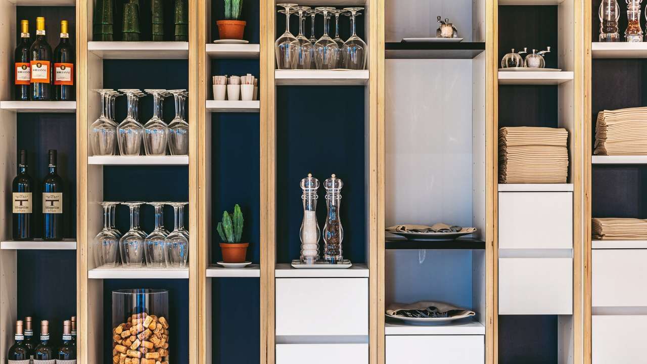 A wine rack with bottles and glasses.