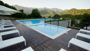 Seasonal outdoor pool, open 10:00 AM to 8:00 PM, pool umbrellas
