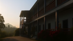 A multi-story building with a central courtyard, balconies, and a flat roof. - Sipanya Guesthouse (Phonsavan)
