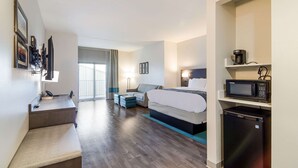 A hotel room with a bed, a desk, a chair, a microwave, and a refrigerator. - Comfort Inn & Suites Gulf Shores East Beach near Gulf State Park (Gulf Shores)