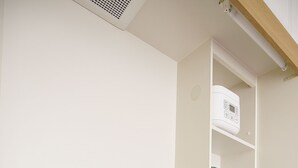 A kitchen with a stainless steel sink, a built-in scale, and wooden cabinets. - Grand Court Namba 501 (Osaka)
