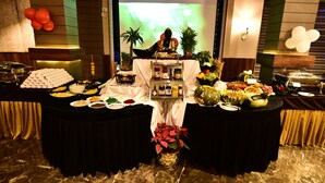 Ein Buffet mit verschiedenen Speisen und einer Buddha-Statue in der Mitte.