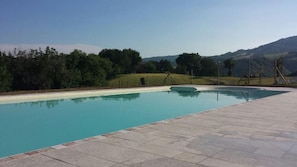 Outdoor pool, open 9:00 AM to 7:00 PM, pool umbrellas, pool loungers