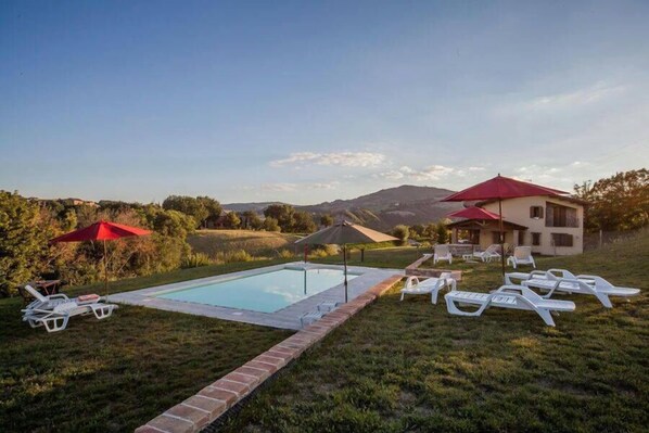 Outdoor pool, open 9:00 AM to 7:00 PM, pool umbrellas, pool loungers