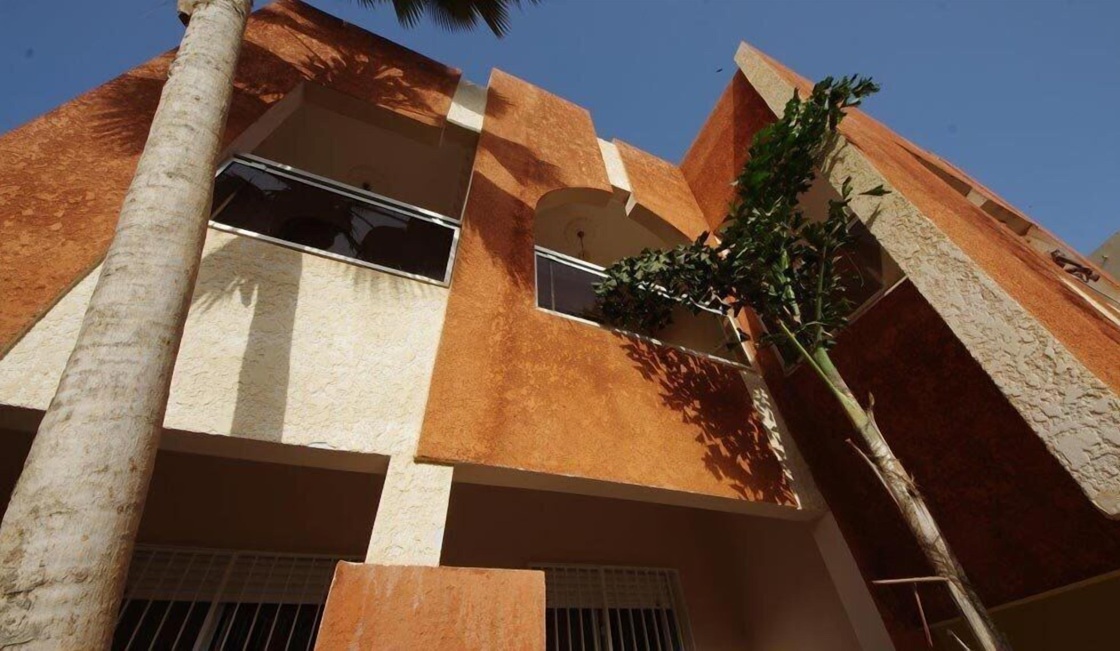 A multi-story building with a modern architectural style, featuring a mix of brick and stucco exteriors.