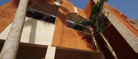 A multi-story building with a modern architectural style, featuring a mix of brick and stucco exteriors.