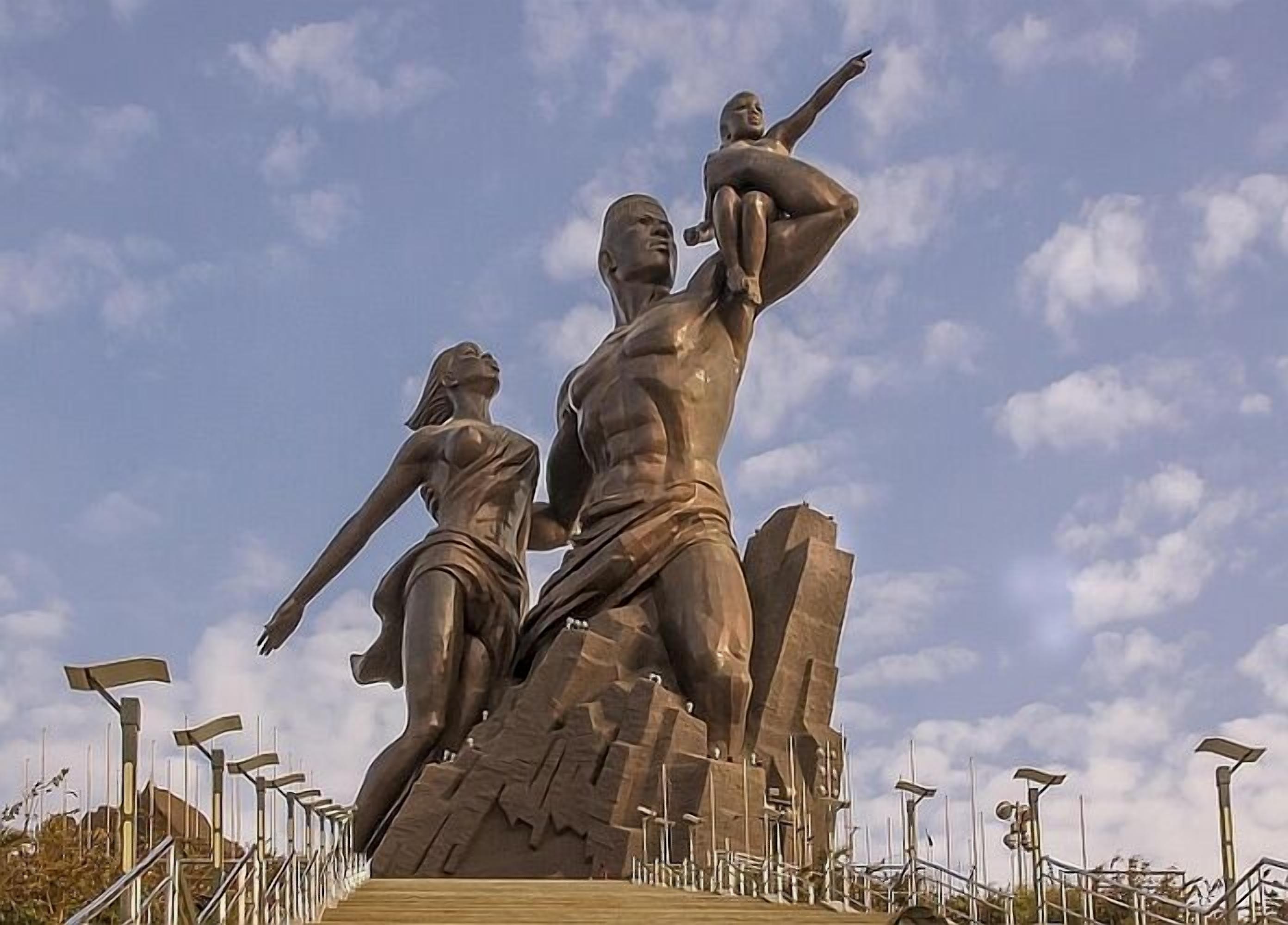 A large outdoor sculpture of a man and woman with a child.