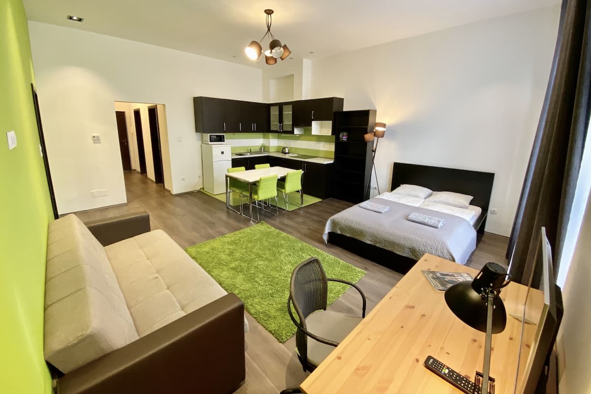 Family Apartment, Garden View | Living area | Flat-screen TV