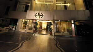 A modern hotel with a prominent entrance, multiple balconies, and a well-lit facade. - Holiday Home Suites (Beirut)
