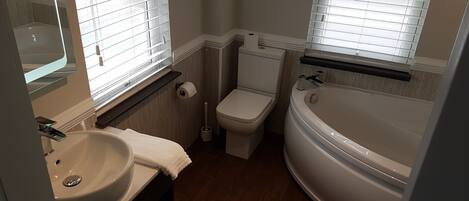 A bathroom with a sink, toilet, and bathtub.