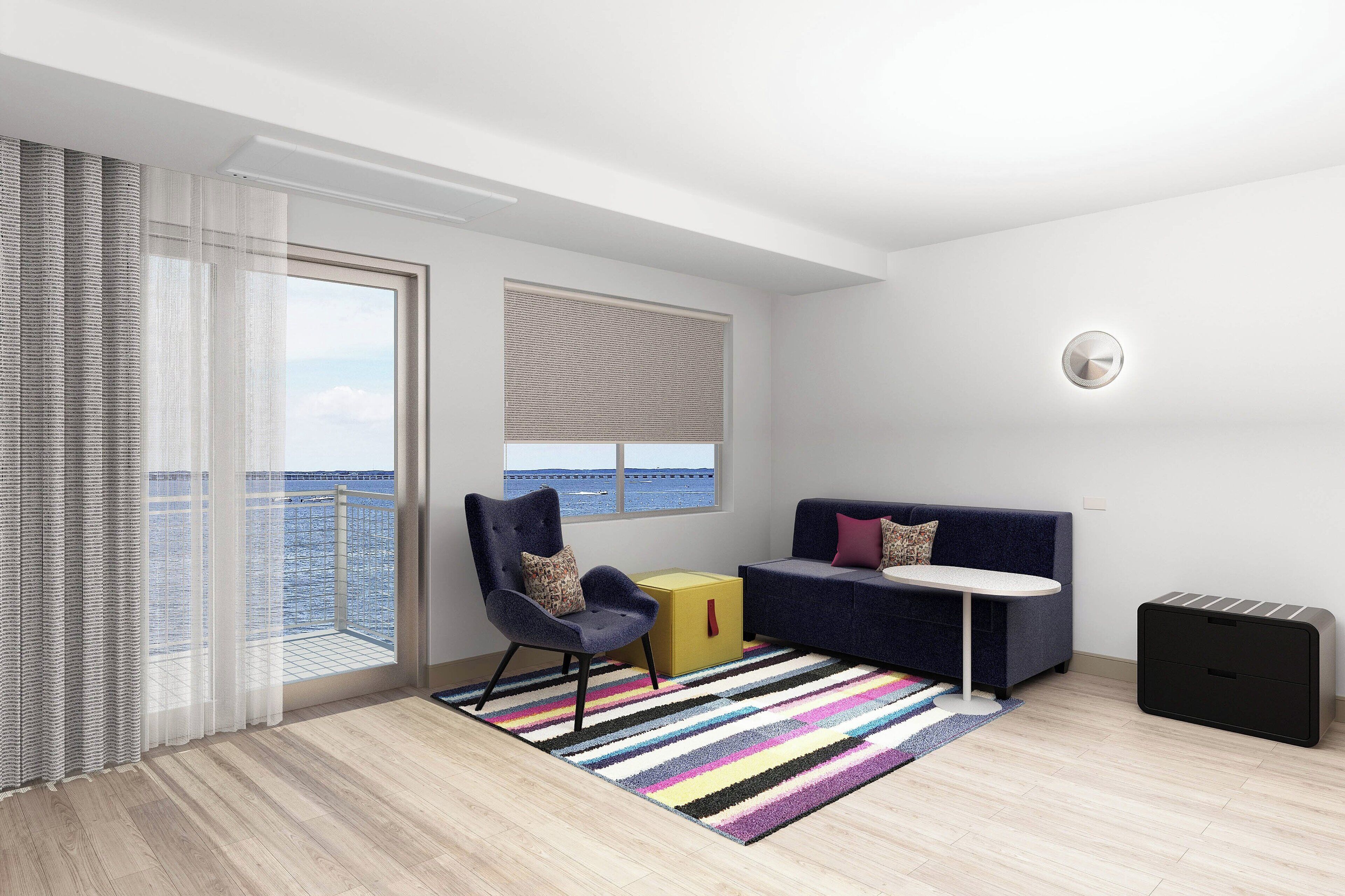 A modern living room with a sofa, armchair, and a small table.