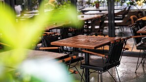 A restaurant interior with wooden tables and black chairs. - Milord Hotel (Istanbul)