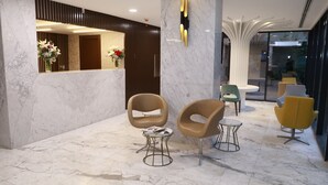 A modern lobby with marble flooring, a reception desk, and contemporary seating arrangements. - Milord Hotel (Istanbul)