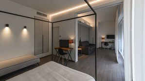 A modern hotel room with a bed, desk, and seating area. - B&B The Attico (Florence)