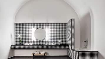 Bathroom features a checkered tile pattern, a large mirror, and a bathtub.