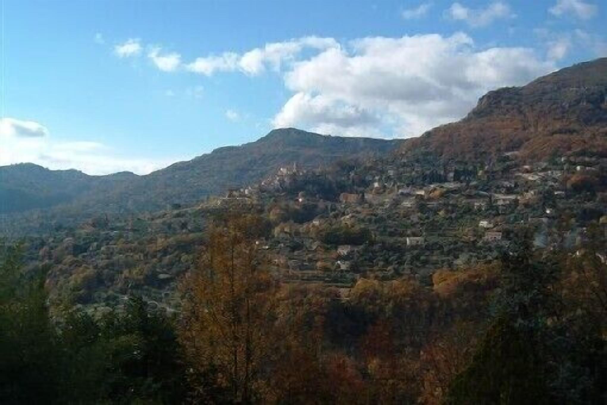 A mountainous landscape with a town nestled in the valley.