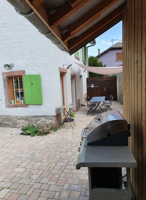Enjoy al fresco dining on the patio, where a barbecue grill and comfortable seating await.