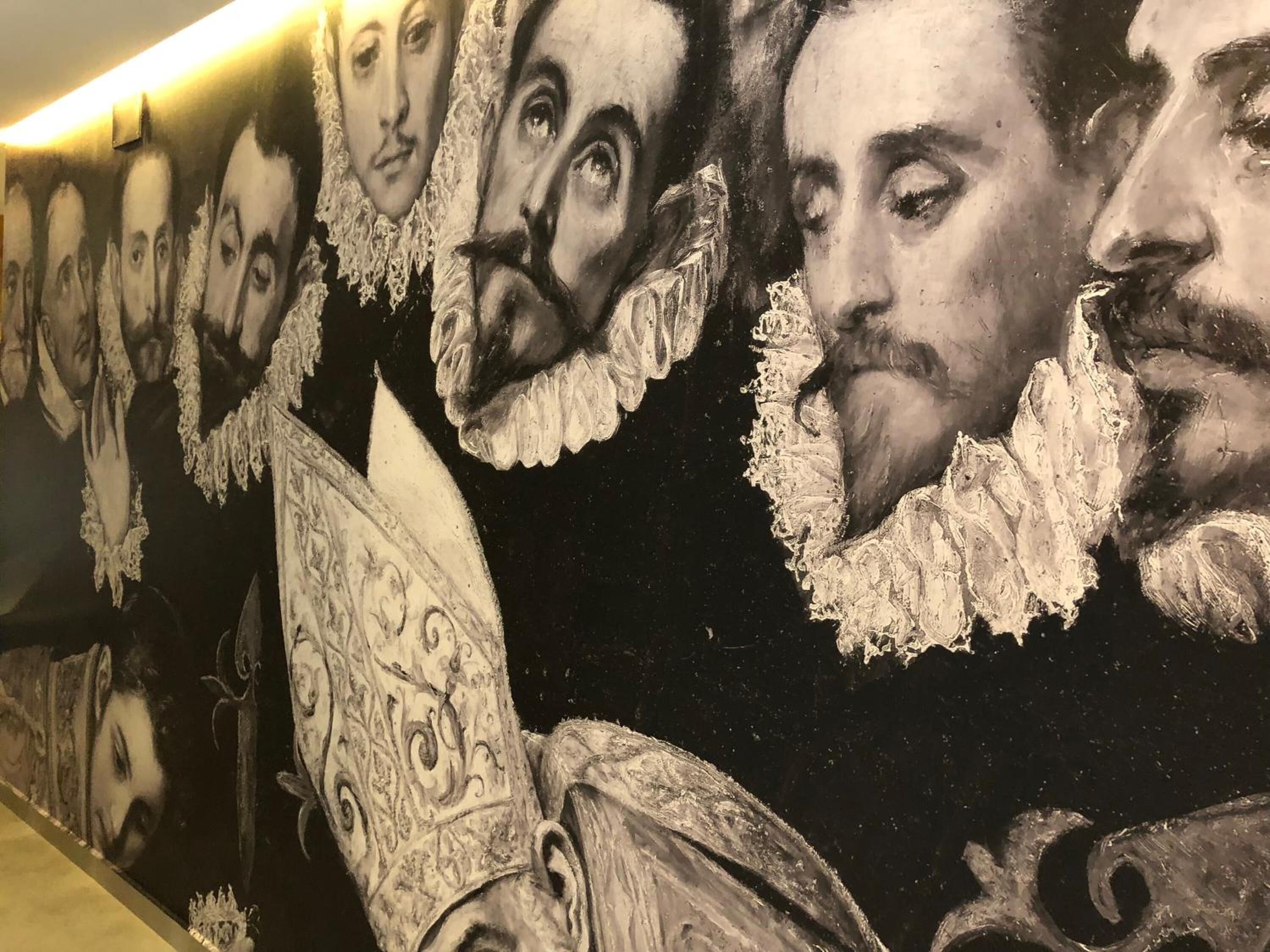 A detailed mural with portraits of individuals in historical attire.